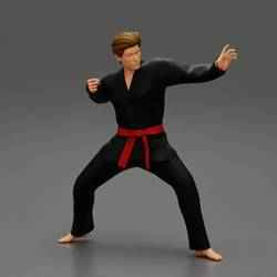 Karate man in a black kimono with a red belt