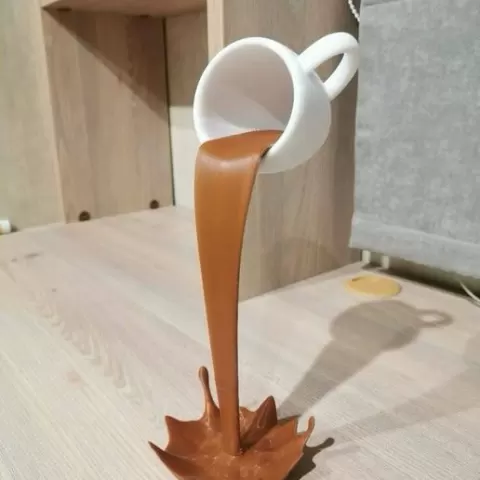 Decorative floating cup with spilled liquid