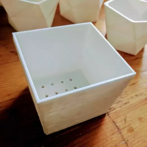 Flower pot with drain hole and elevated bottom
