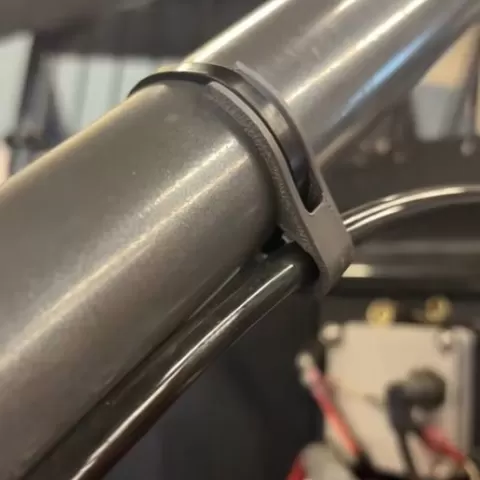 Shock adjuster cable clamp