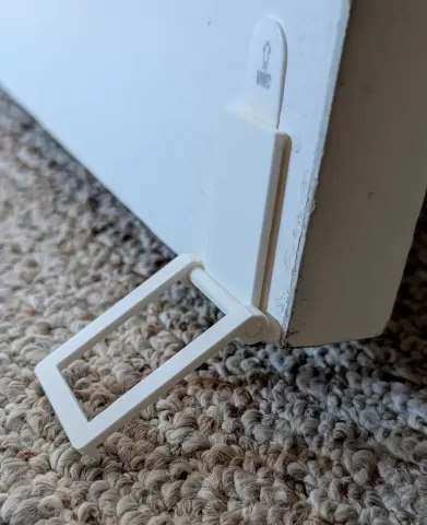 Hinged door stop for carpeted floor