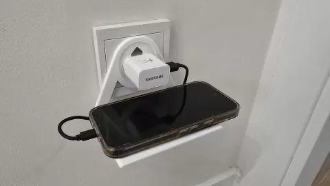 Mobile phone holder plugged into a European socket