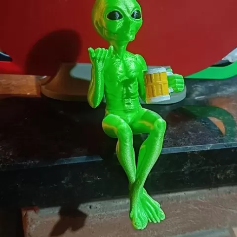 ET Extraterrestrial Alien Sitting with beer in hand and hangloose in the other hand