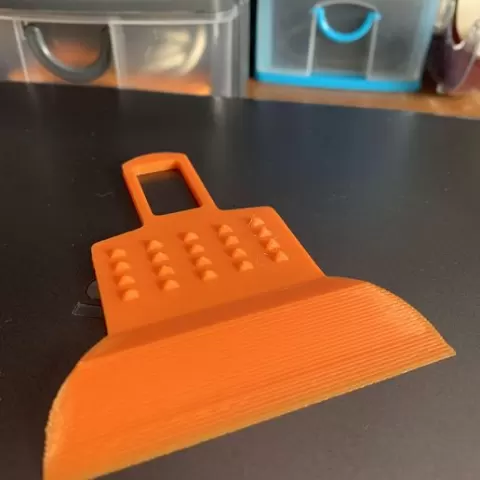 Ice scraper and buckle silencer