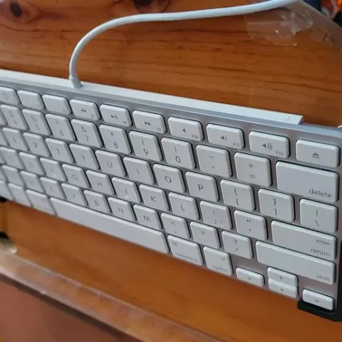 Wired Apple mini keyboard wall mount.